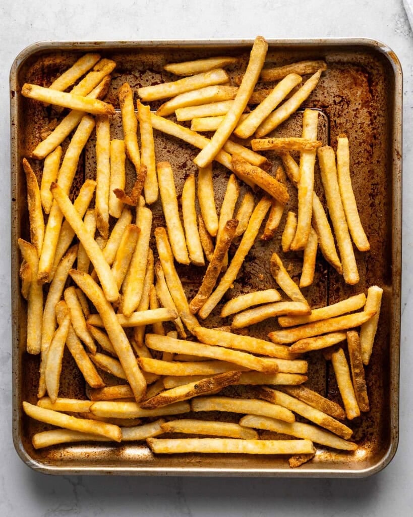 French fries cooked on an air fryer tray.