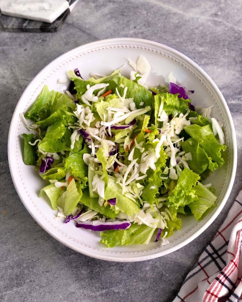 Lettuce and coleslaw mix combined in a bowl.