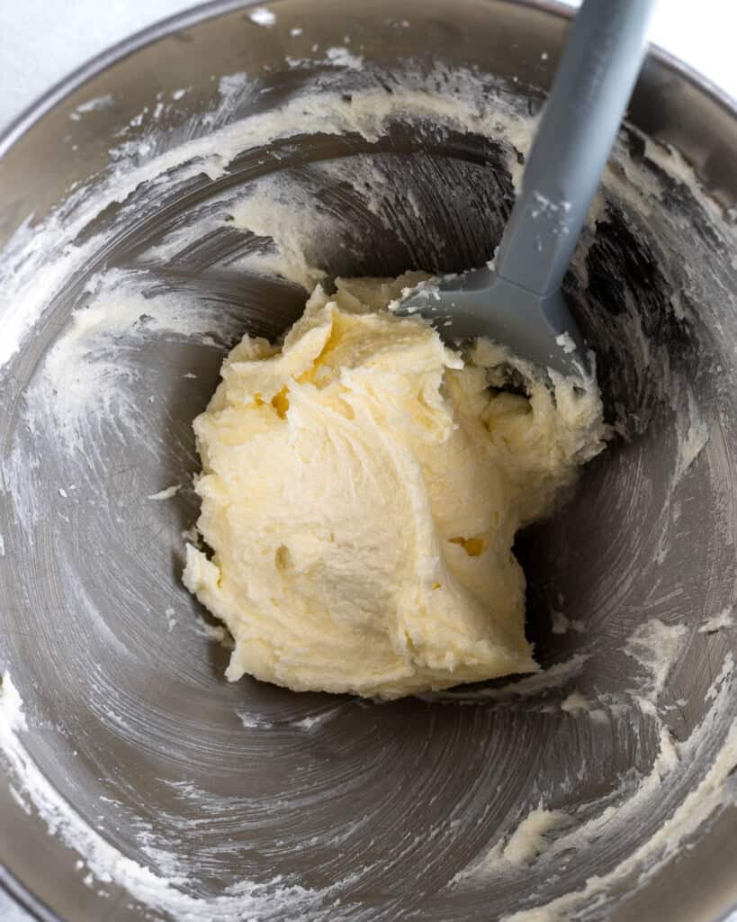 Butter and sugar creamed together in a stand mixer bowl.