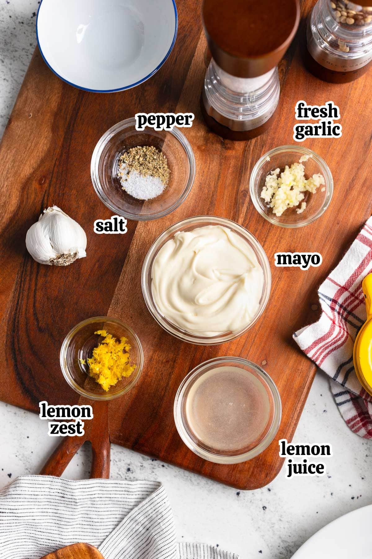 Text-labeled lemon aioli ingredients in bowls.