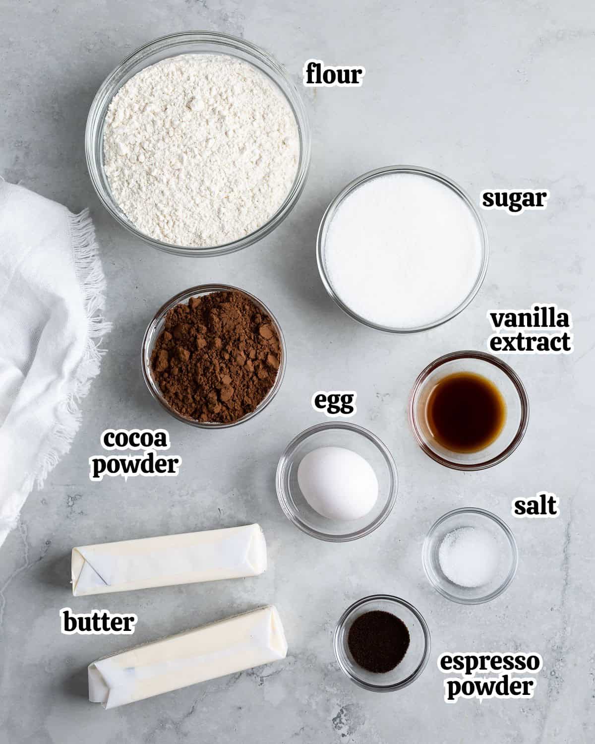 Text-labeled chocolate spritz cookie ingredients in separate containers.