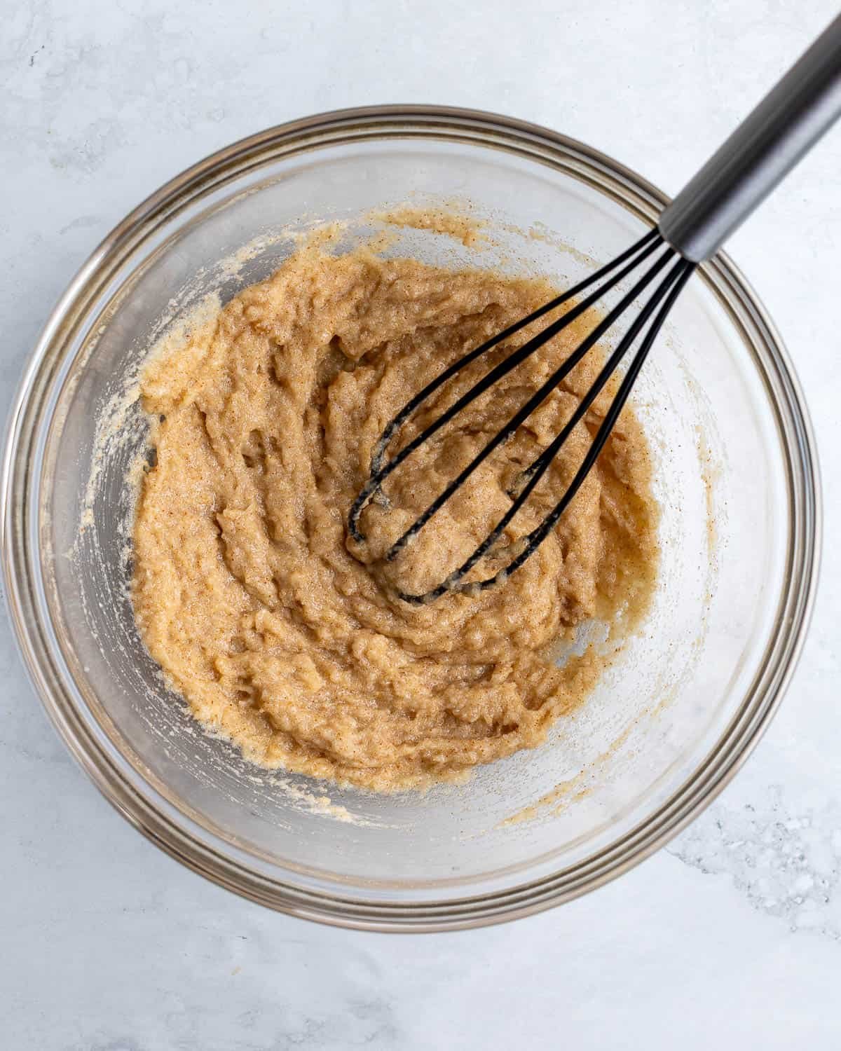 Brown sugar, granulated sugar, and melted browned butter whisked together in a bowl.