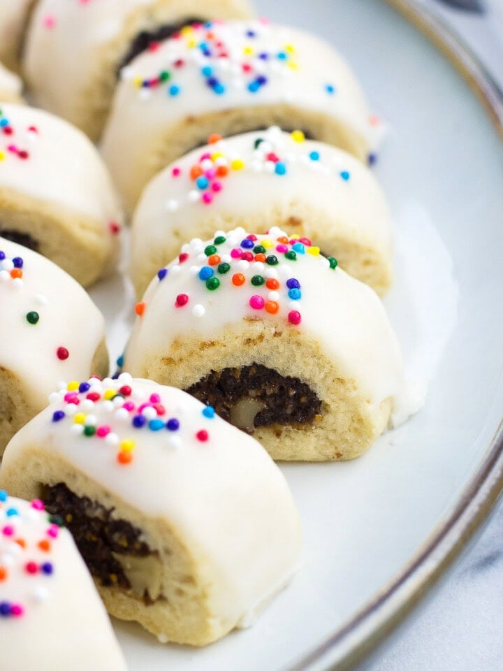 Glazed cucidati lined up next to one another on a serving plate