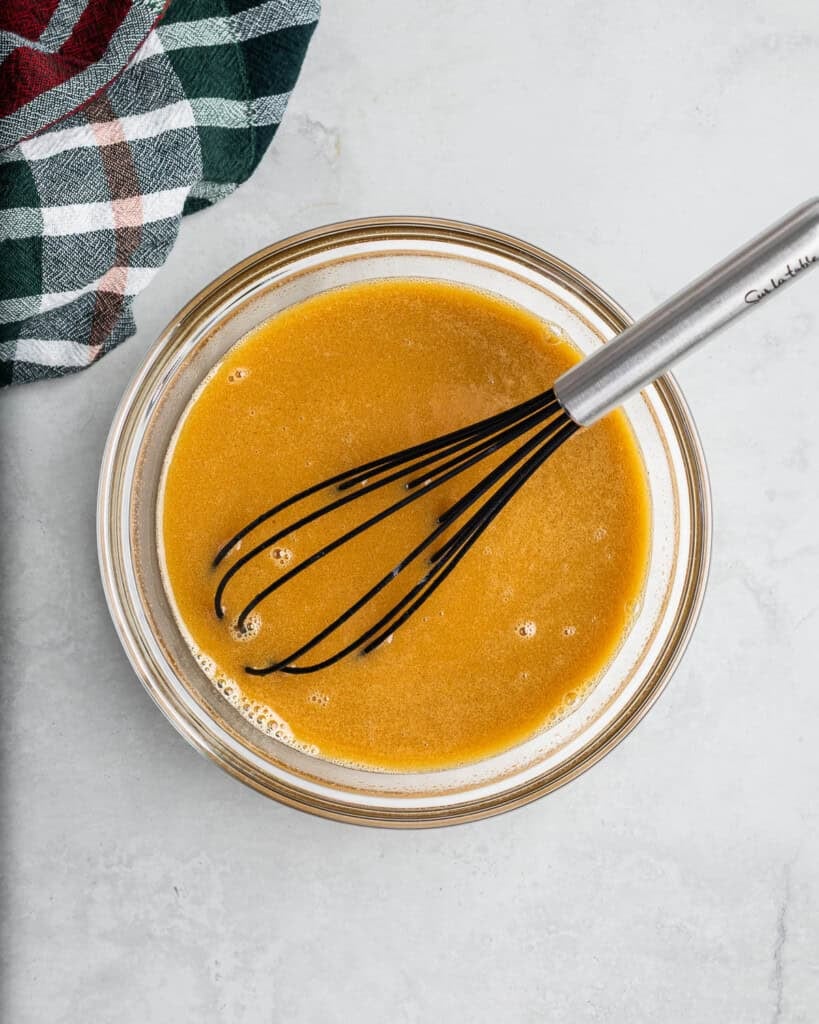 Wet ingredients whisked together in a bowl.