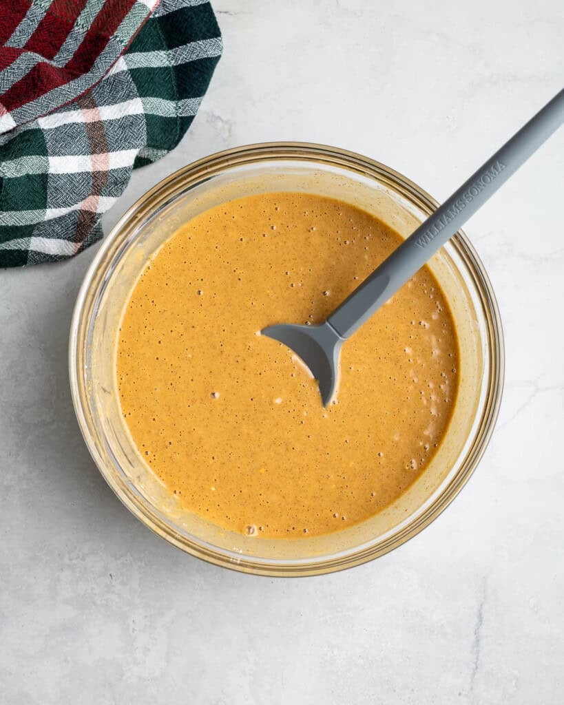 The gingerbread waffle batter combined in a mixing bowl.
