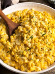 A serving bowl of roasted garlic creamed corn.