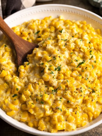 A serving bowl of roasted garlic creamed corn.