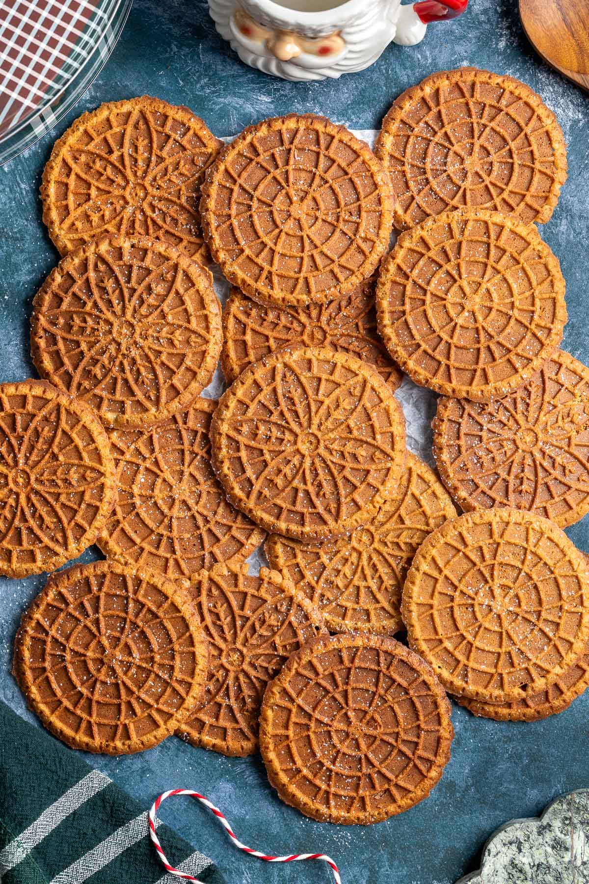Overlapping layers of gingerbread pizzelle lightly dusted with powdered sugar.