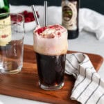 A chocolate raspberry beer float garnished with fresh raspberries.