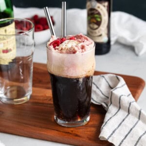 A chocolate raspberry beer float garnished with fresh raspberries.