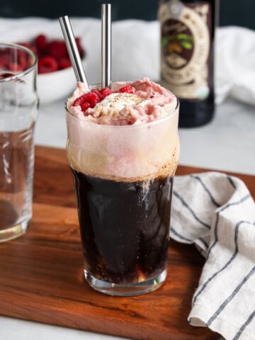 A chocolate raspberry beer float garnished with fresh raspberries.