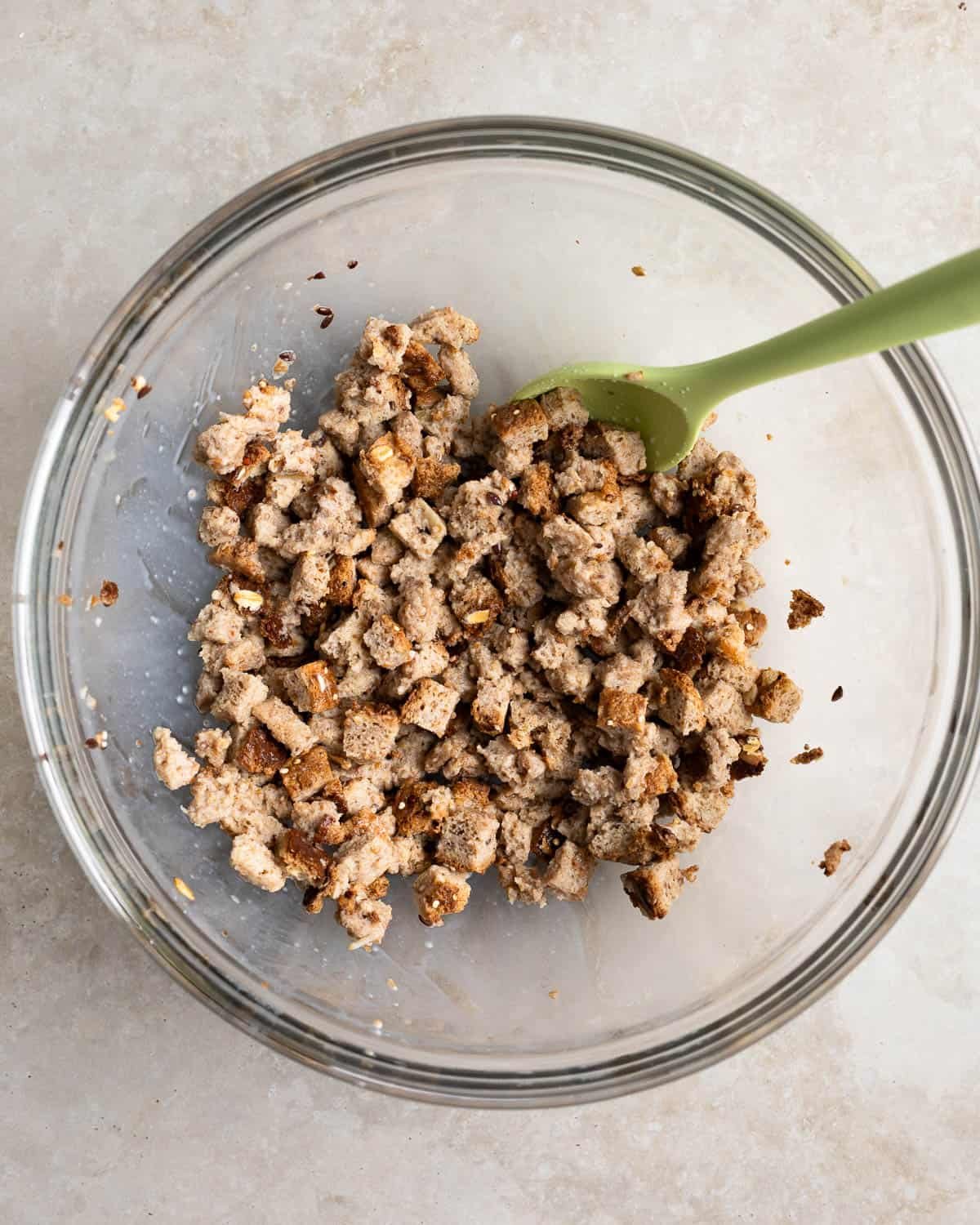 Breadcubes and milk in a glass mixing bowl.
