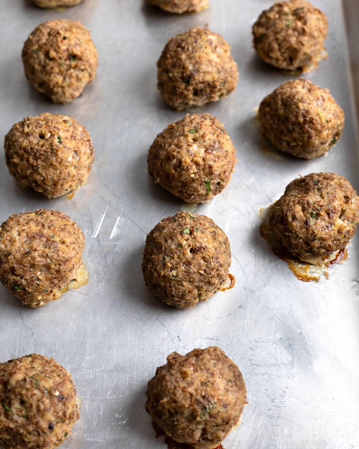 Baked fiber turkey meatballs on a pan.