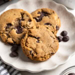 Three golden-brown chocolate chip cookies made with olive oil.