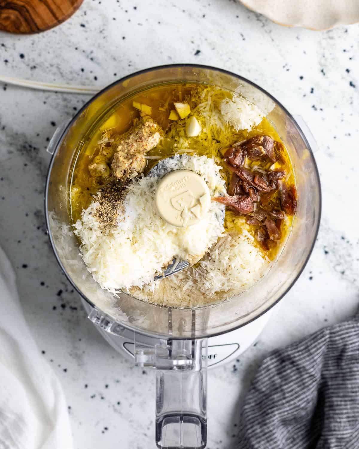 Dressing ingredients added to a food processor before blending.