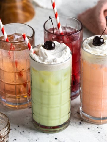 Italian sodas and Italian cream sodas in tall glasses with straws.