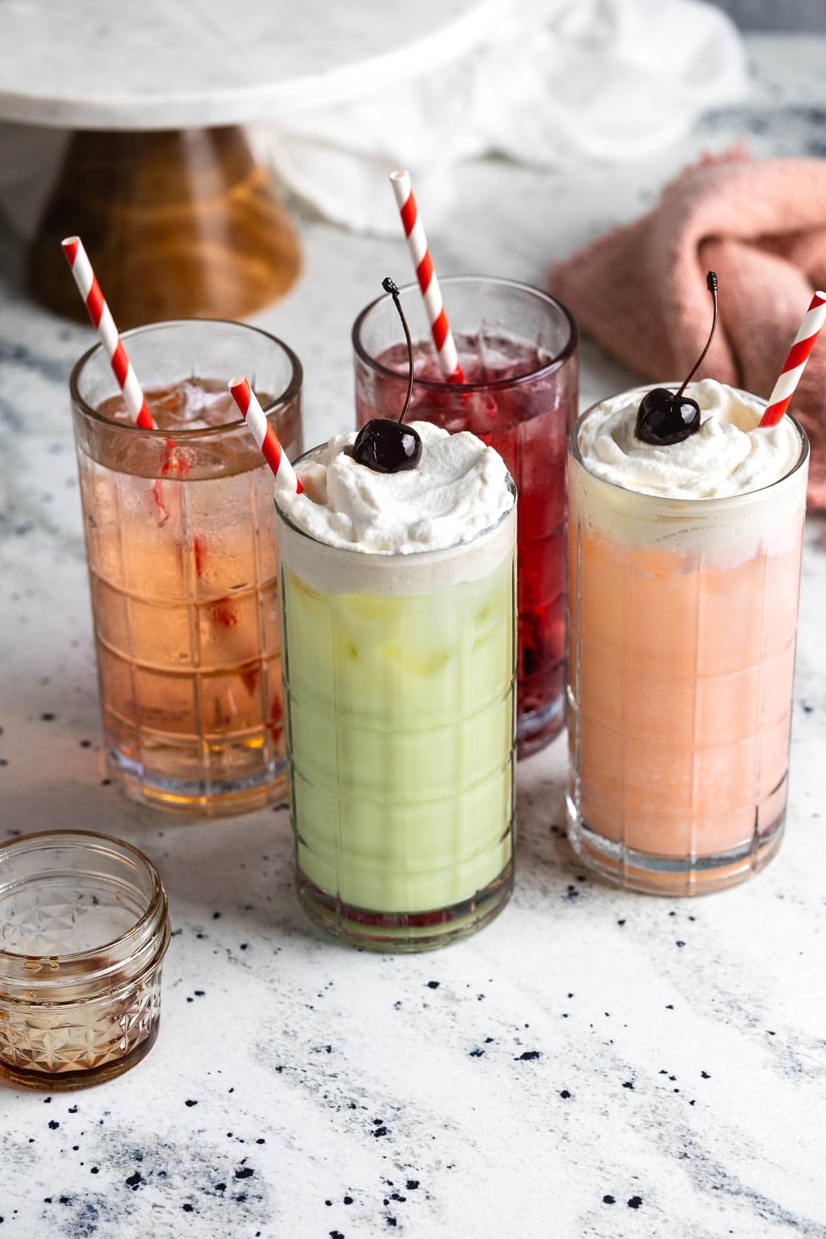 Italian sodas and Italian cream sodas in tall glasses with straws.