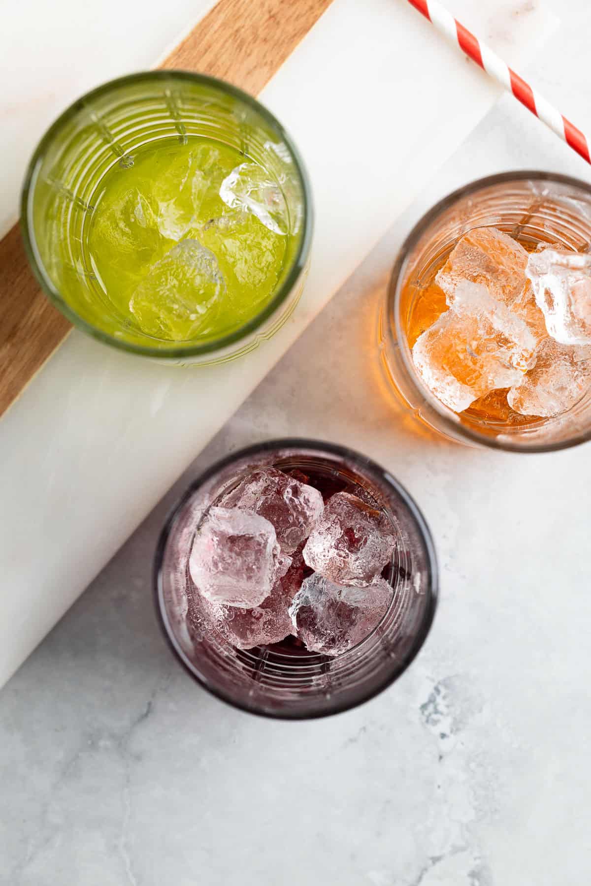 Flavored syrups poured over ice in tall glasses.