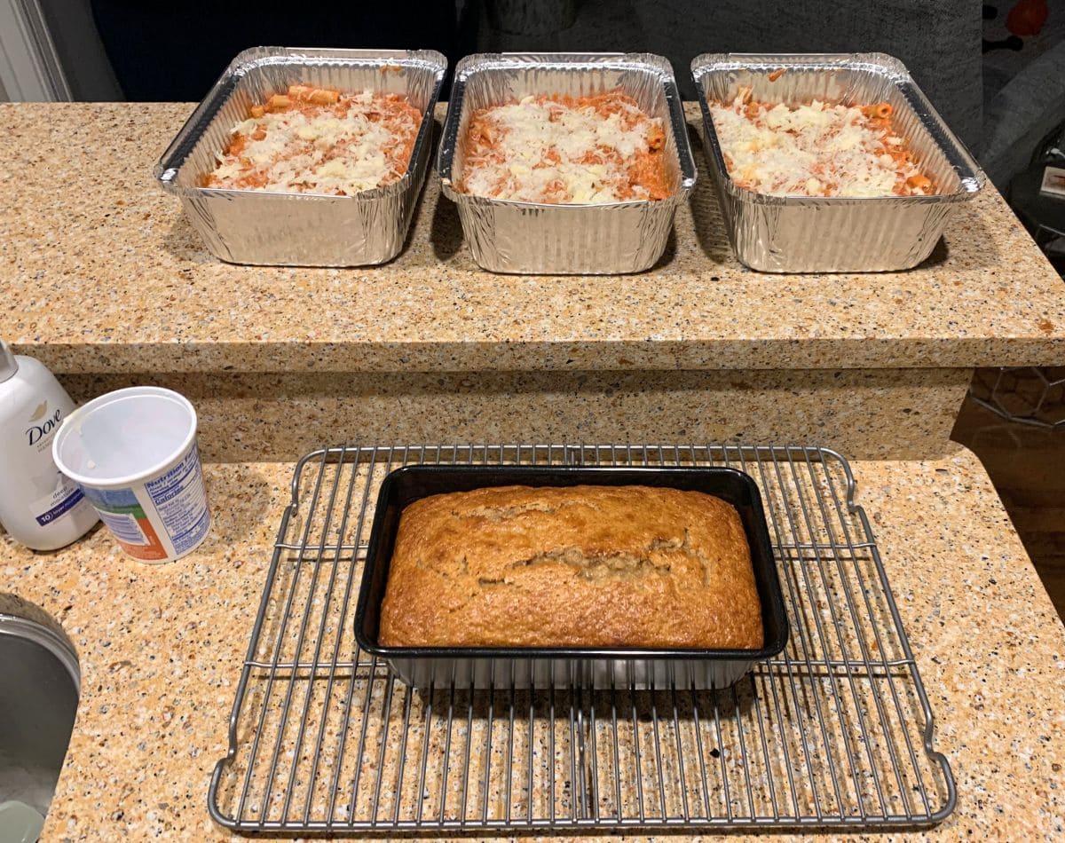Meal prepping medium trays of baked ziti and a loaf of banana bread.