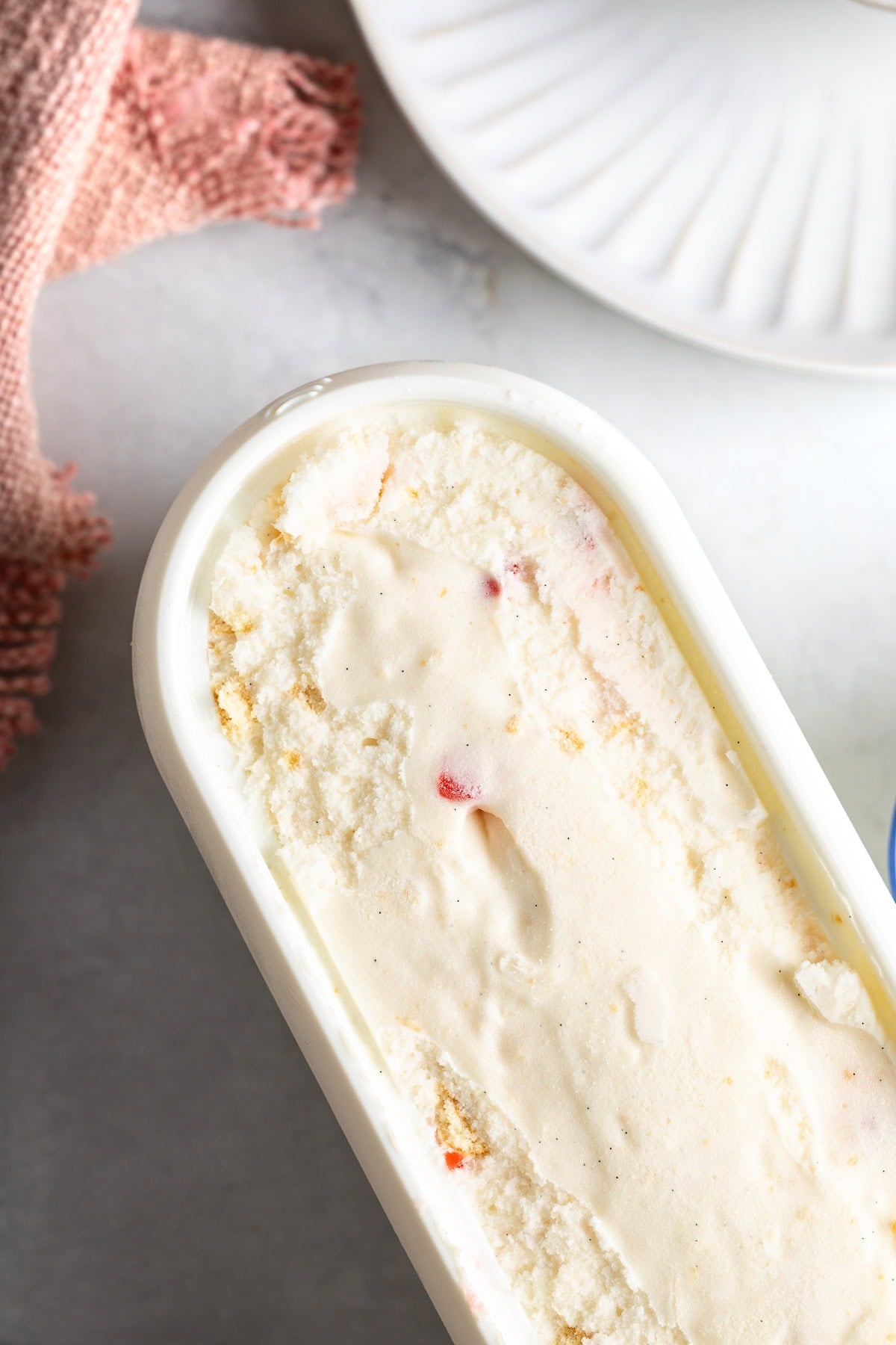 The solidified frozen yogurt mixture in a storage tub.