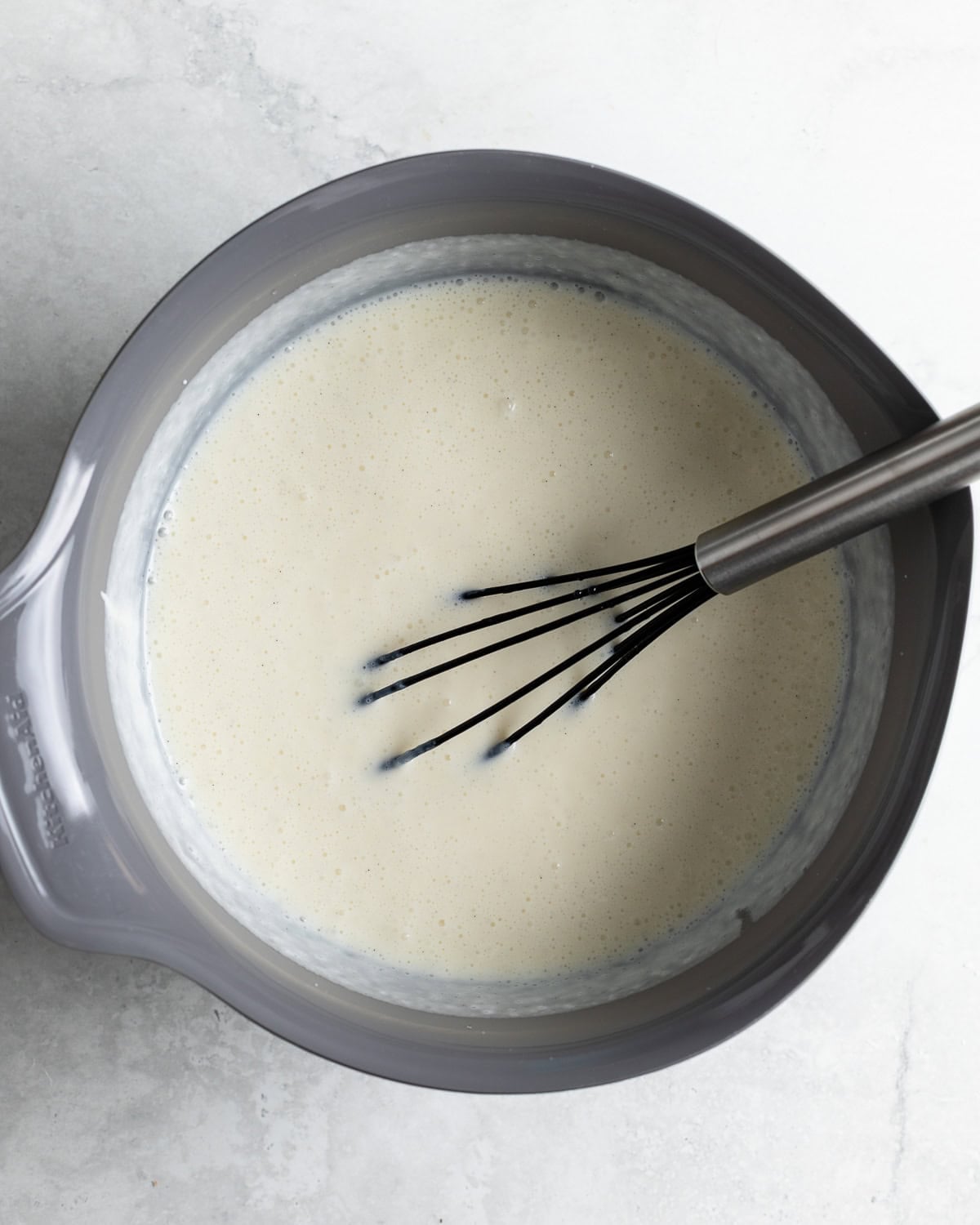 The pineapple frozen yogurt mixture whisked together in a large bowl.