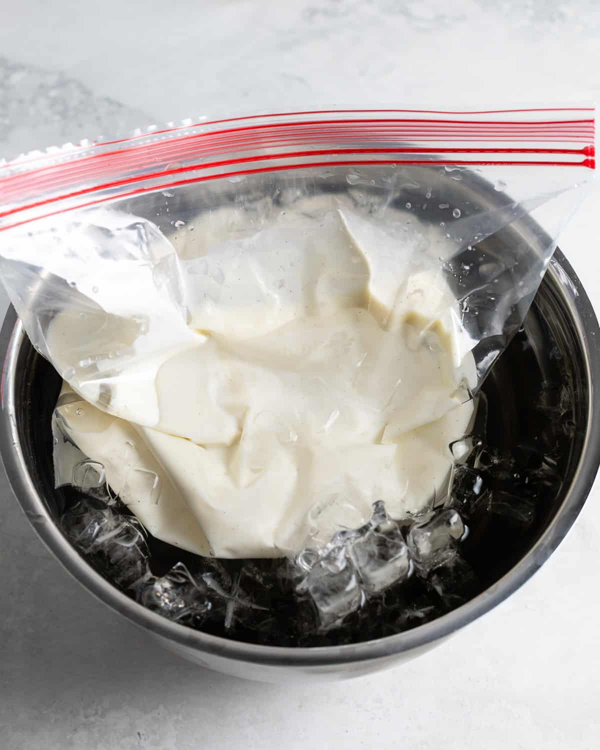 The frozen yogurt mixture in an ice bath to cool.