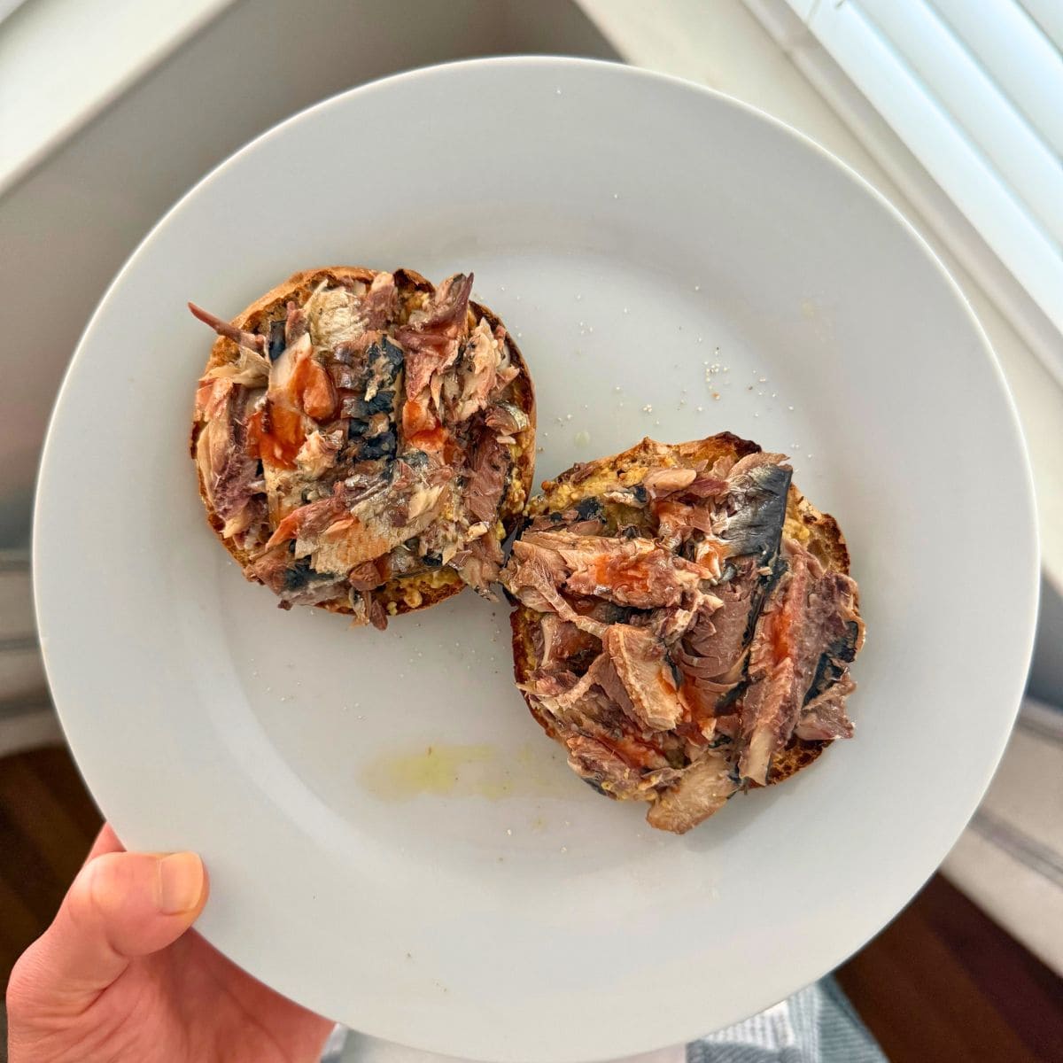 Sardines and hot sauce smushed onto a toasted english muffin.
