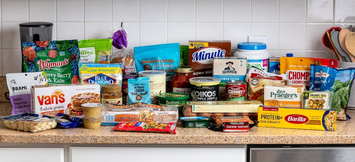 A variety of groceries on a kitchen countertop.