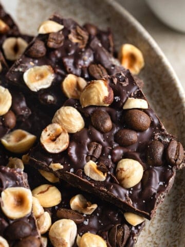 Crispy chocolate bark topped with toasted hazelnuts and whole espresso beans.