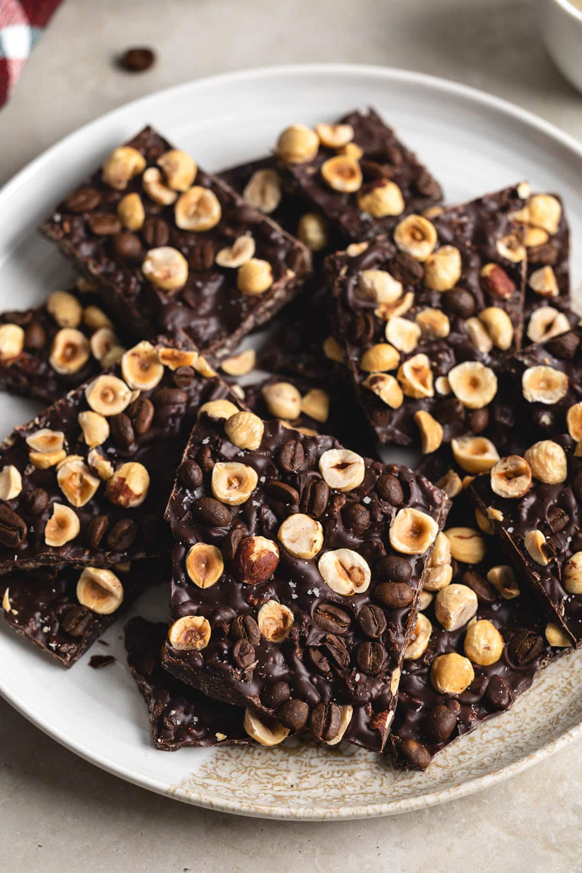 Shards of chocolate hazelnut espresso bark on a plate.