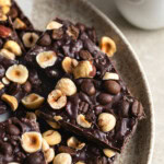 Crispy chocolate bark topped with toasted hazelnuts and whole espresso beans.