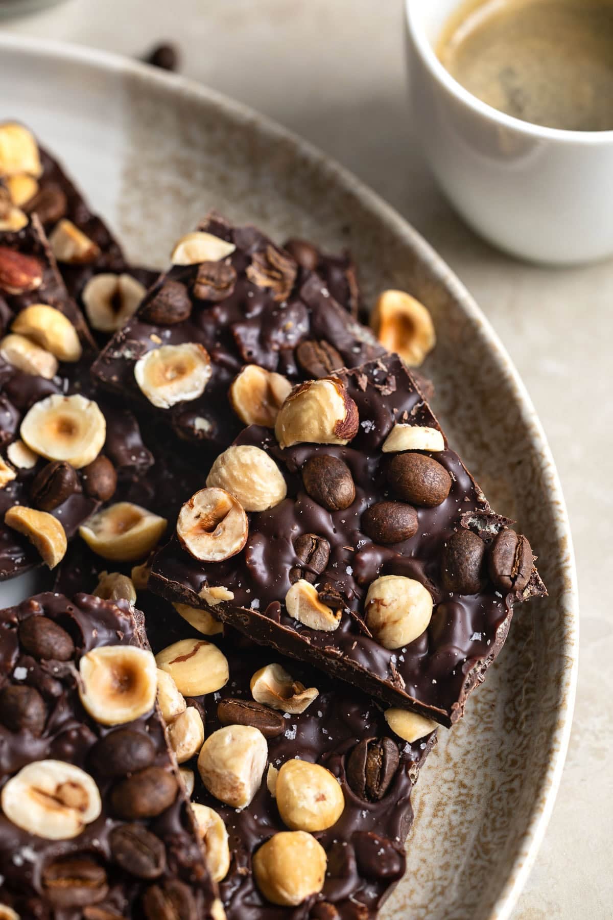Crispy chocolate bark topped with toasted hazelnuts and whole espresso beans.