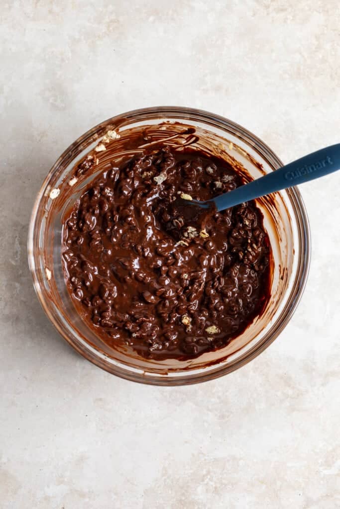 Crispy rice cereal stirred into the bowl of melted chocolate.