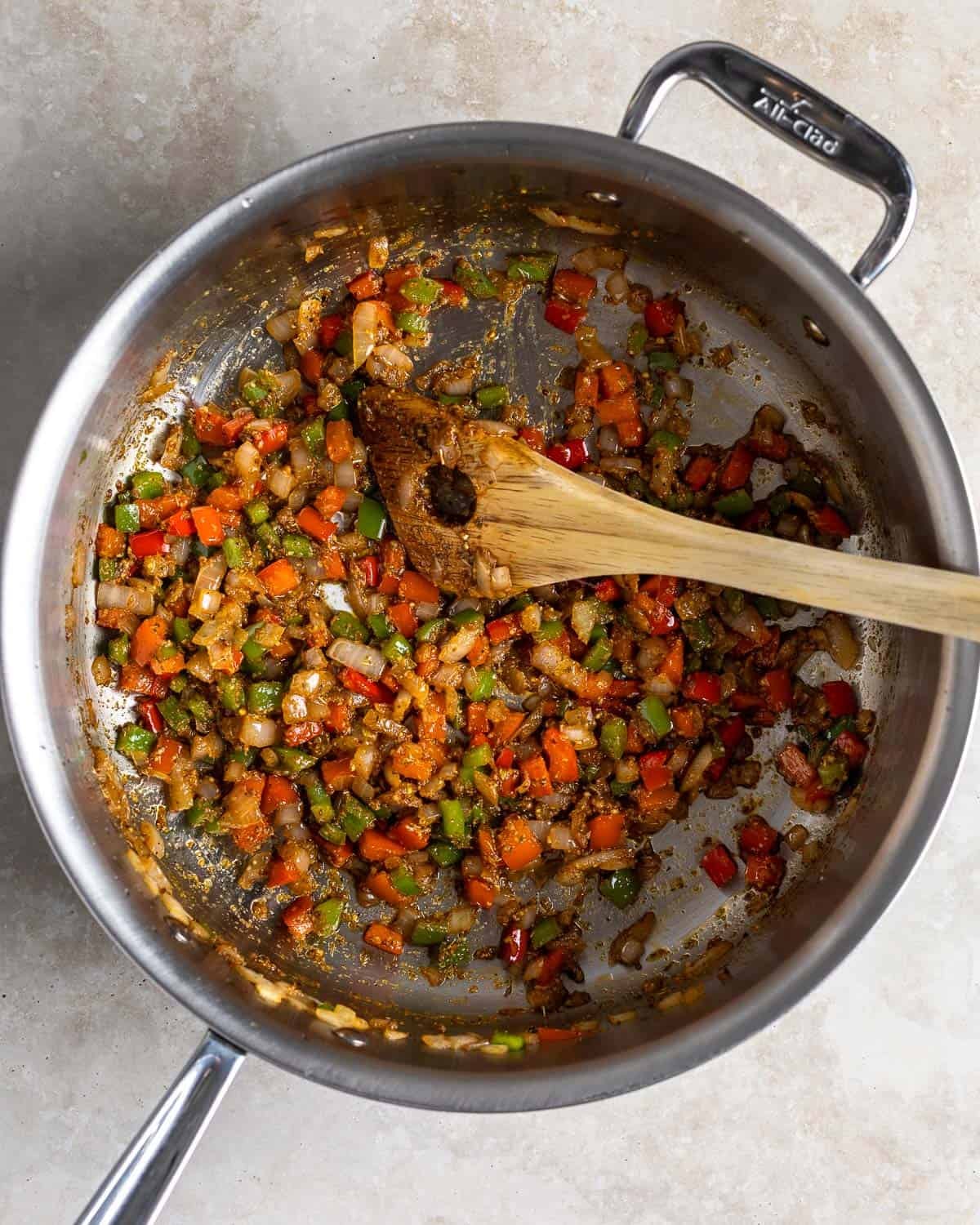 Spices and mustard mixed into the onions and peppers.