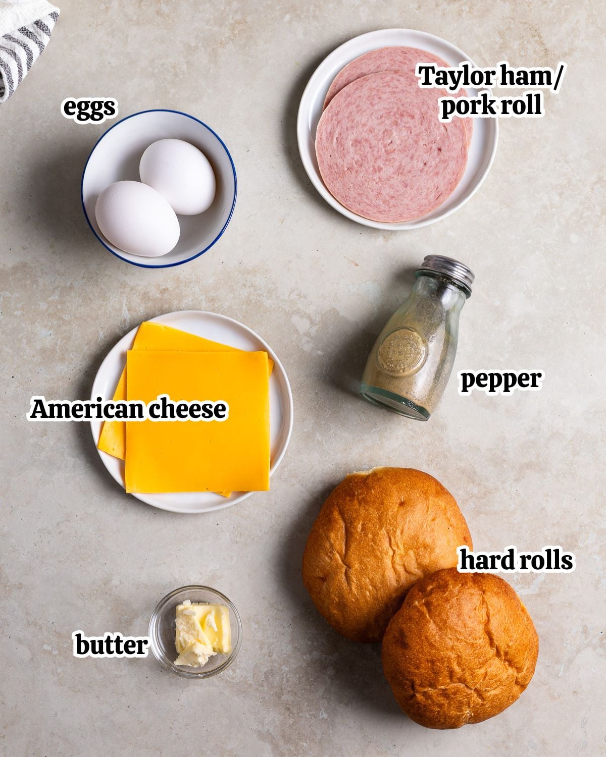 Text-labeled ingredients needed to make a Taylor ham egg and cheese sandwich.