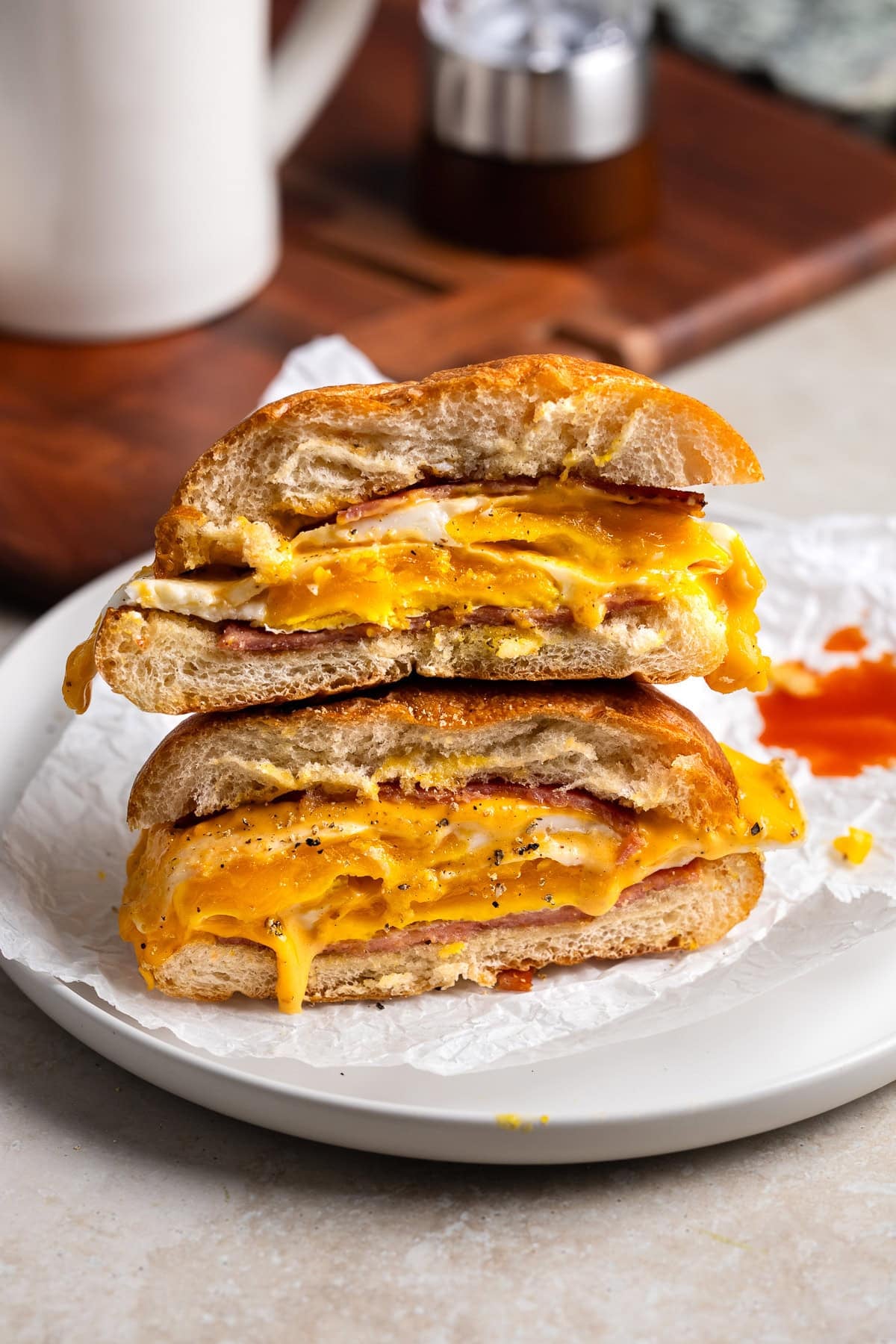 Two halves of a pork roll, egg, and cheese sandwich stacked on top of one another.