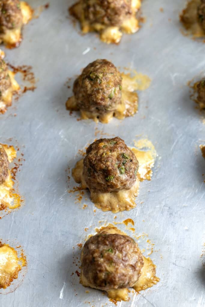 Baked beef meatballs on a sheet pan.