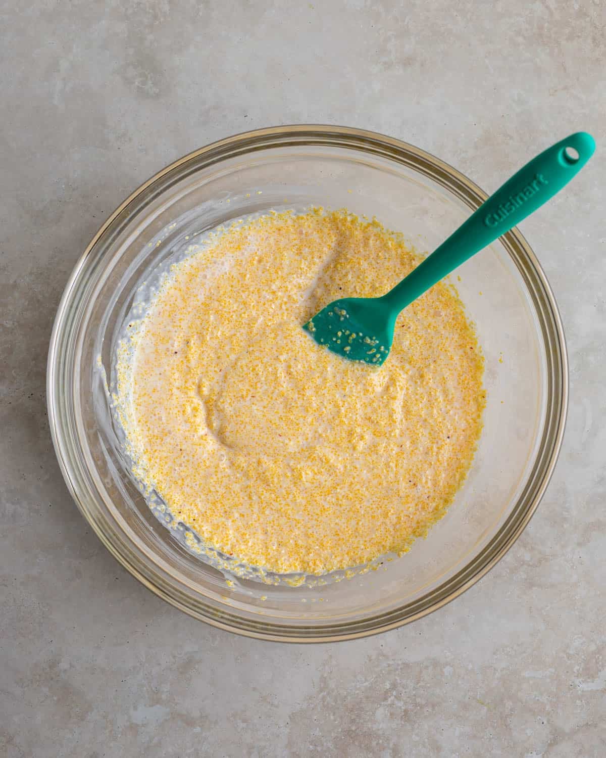 Dry polenta and buttermilk stirred together in a bowl to soak.