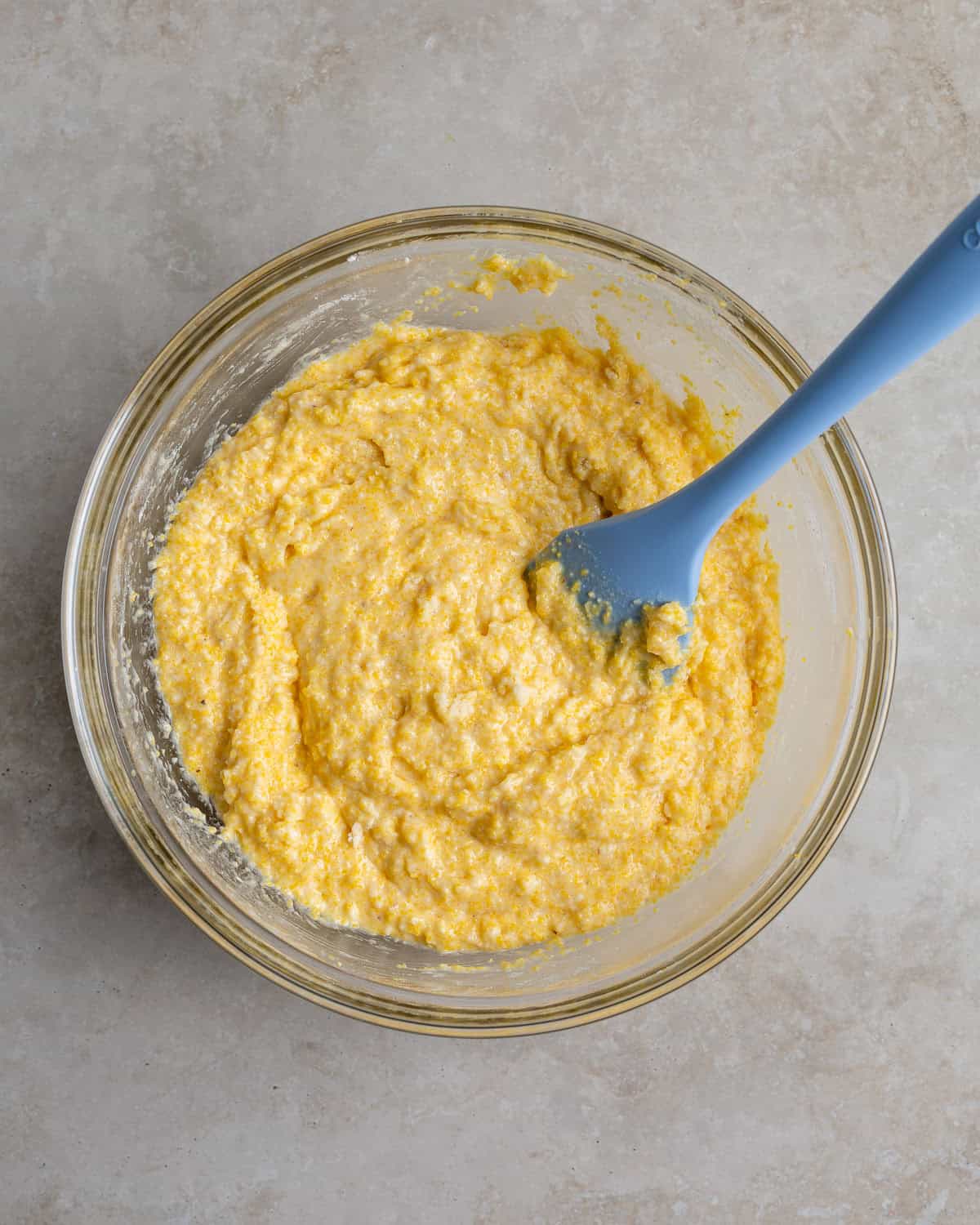 Thick polenta cornbread batter in a bowl before being thinned out.