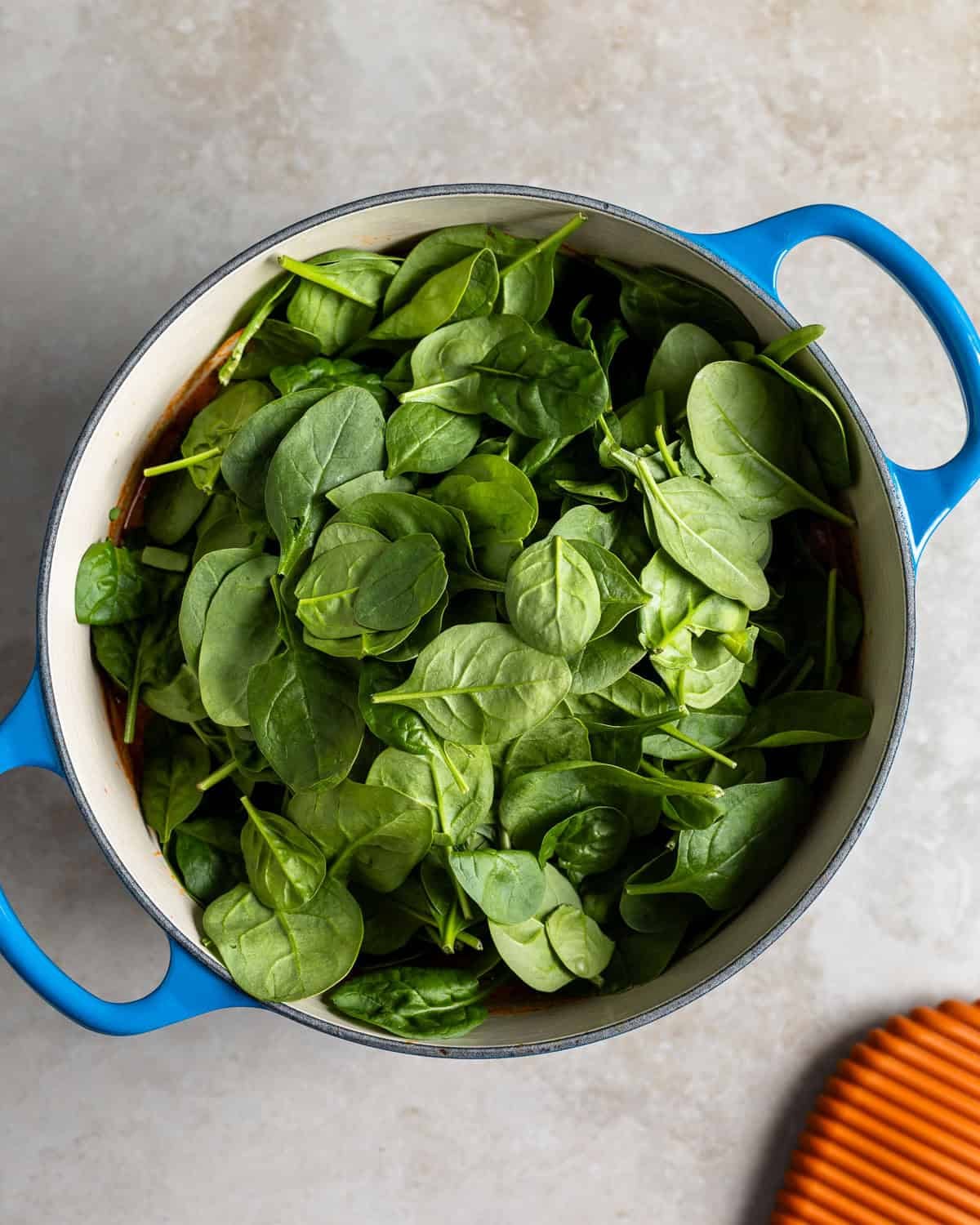 Spinach leaves added to the soup before wilting.
