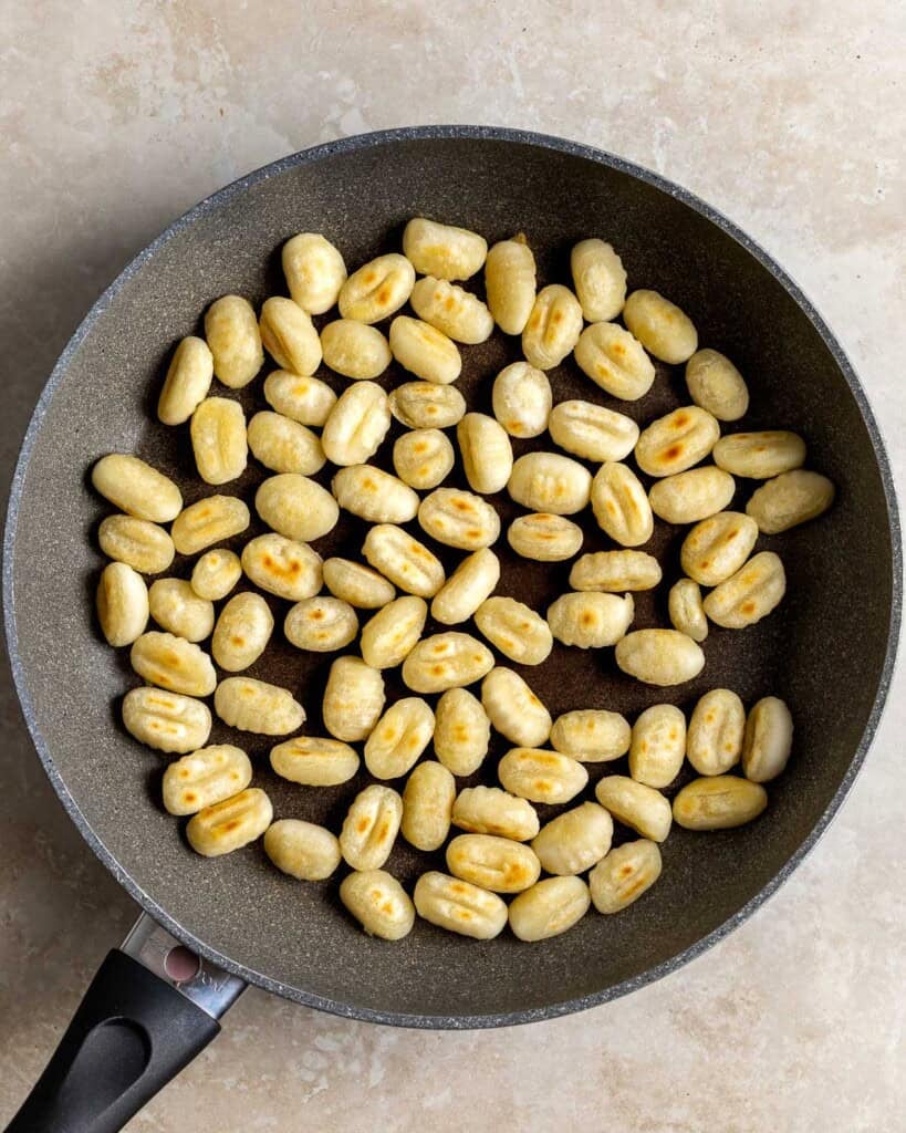 Gnocchi toasted in a pan.
