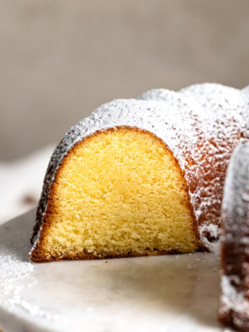 A cross-section of a Philly fluff cake, dusted with powdered sugar.