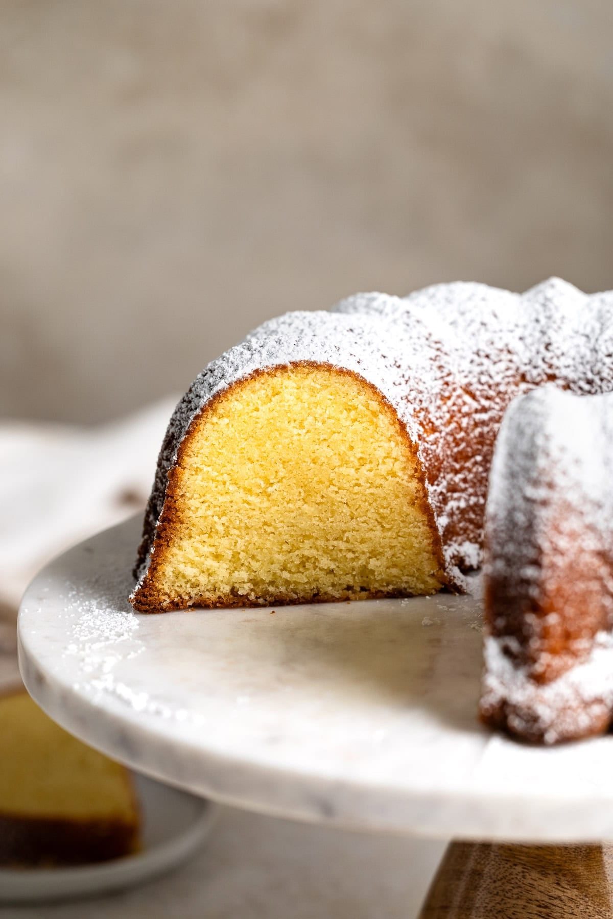 A cross-section of a Philly fluff Bundt cake, dusted with powdered sugar.