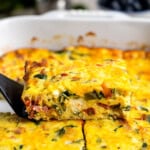 A side profile view of a wedge of ricotta egg bake being lifted out of the pan by a spatula.