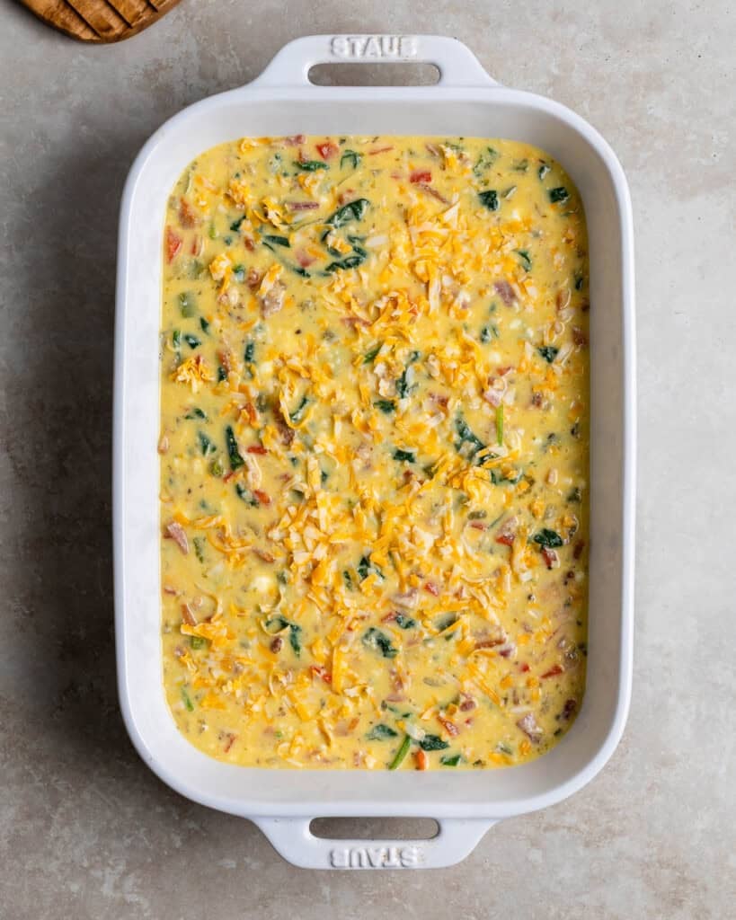 The ricotta egg bake mixture poured into a greased 9-by-13-inch pan.