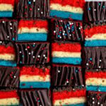 Red white and blue rainbow cookies in an alternating side-profile and top pattern.