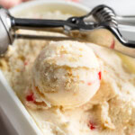 Scoops of pineapple upside down cake frozen yogurt in a storage container.