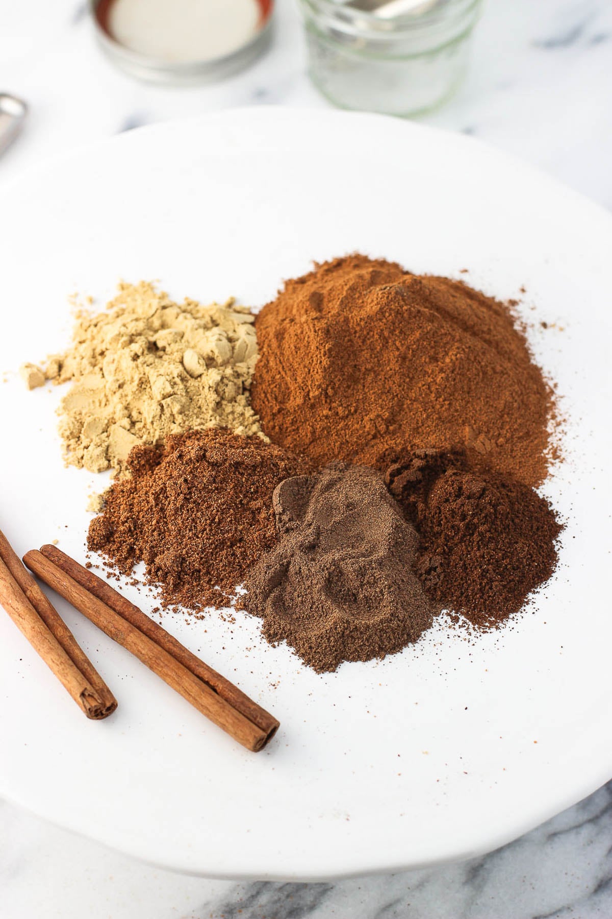 Pie spices in piles next to one another on a plate.