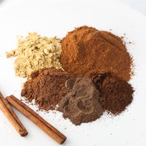 Pie spices in piles next to one another on a plate.