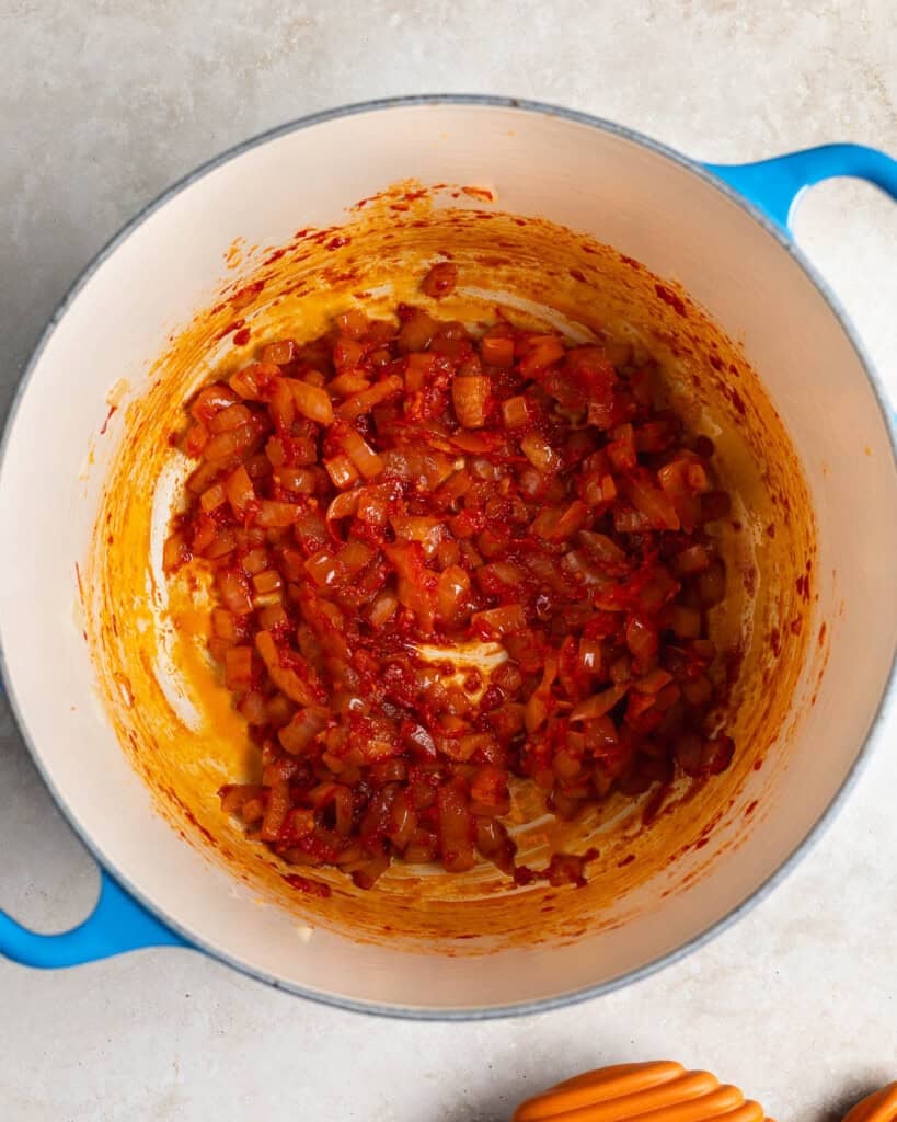 Onion, garlic, and tomato paste sautéed in a Dutch oven.